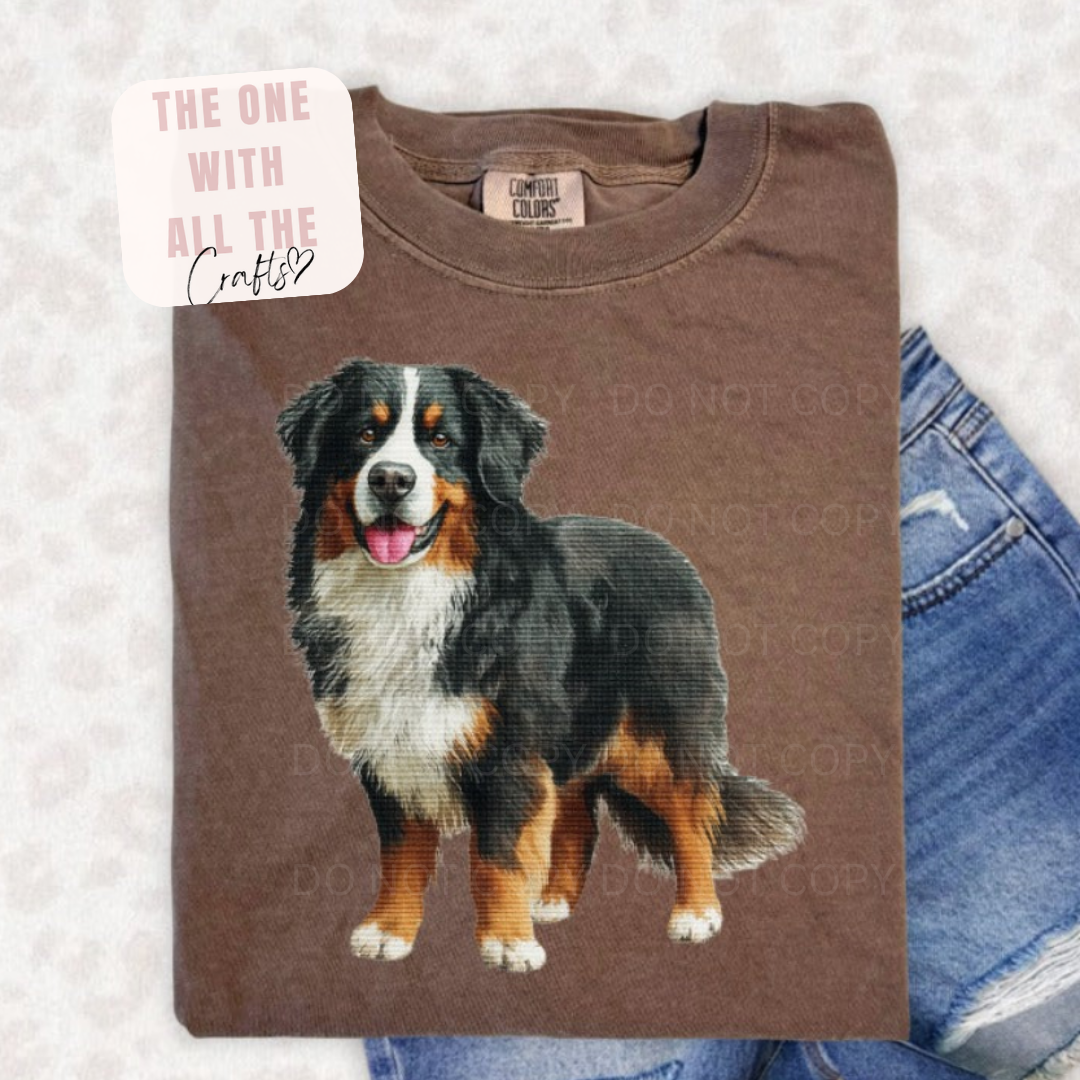 Brown t-shirt with a dog illustration on a textured surface
