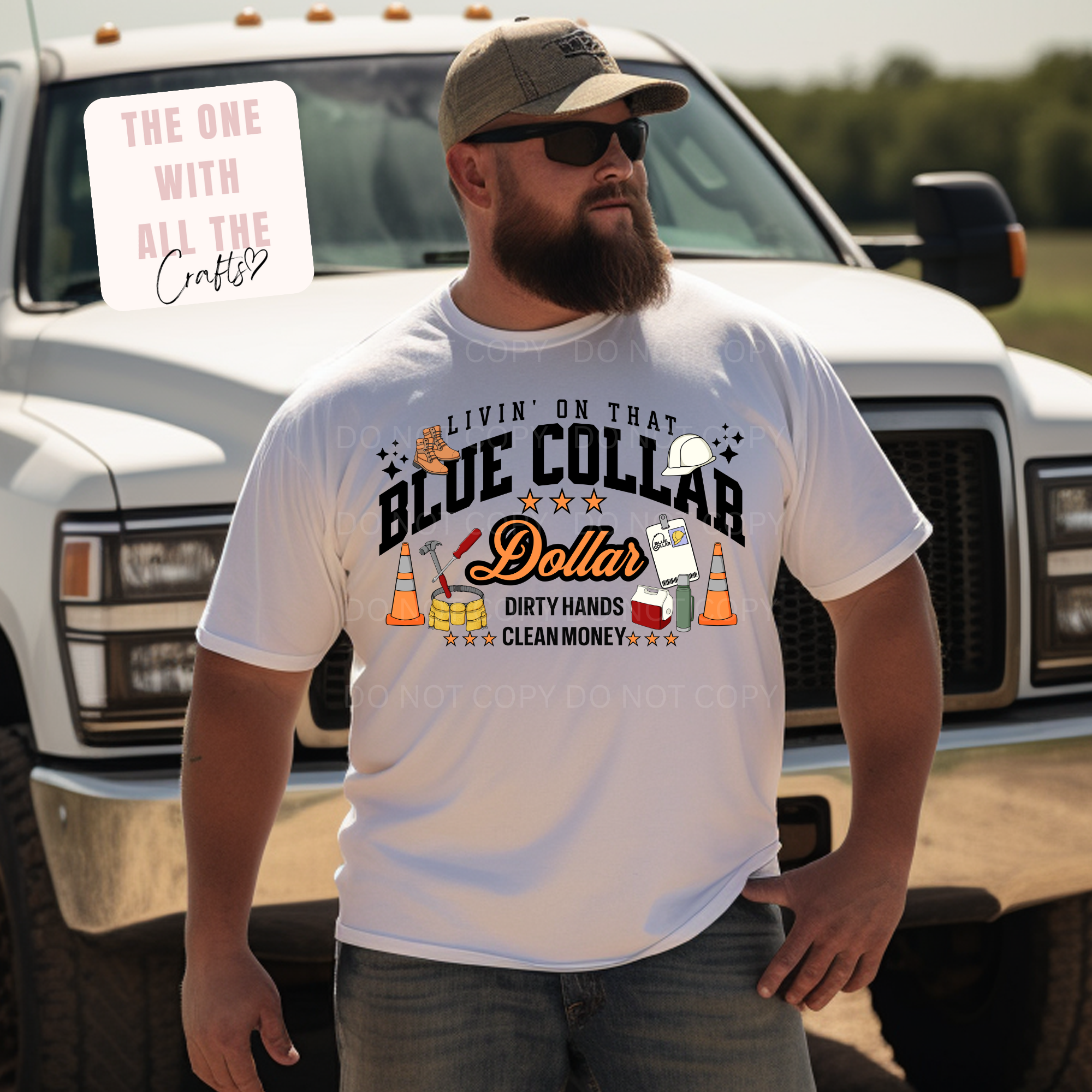 Man wearing a white t-shirt with a graphic design in front of a truck