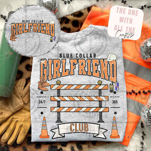 Gray t-shirt with 'Blue Collar Girlfriend Club' design, surrounded by construction-themed accessories.