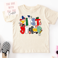 Beige first grade t-shirt with colorful text design on a white background