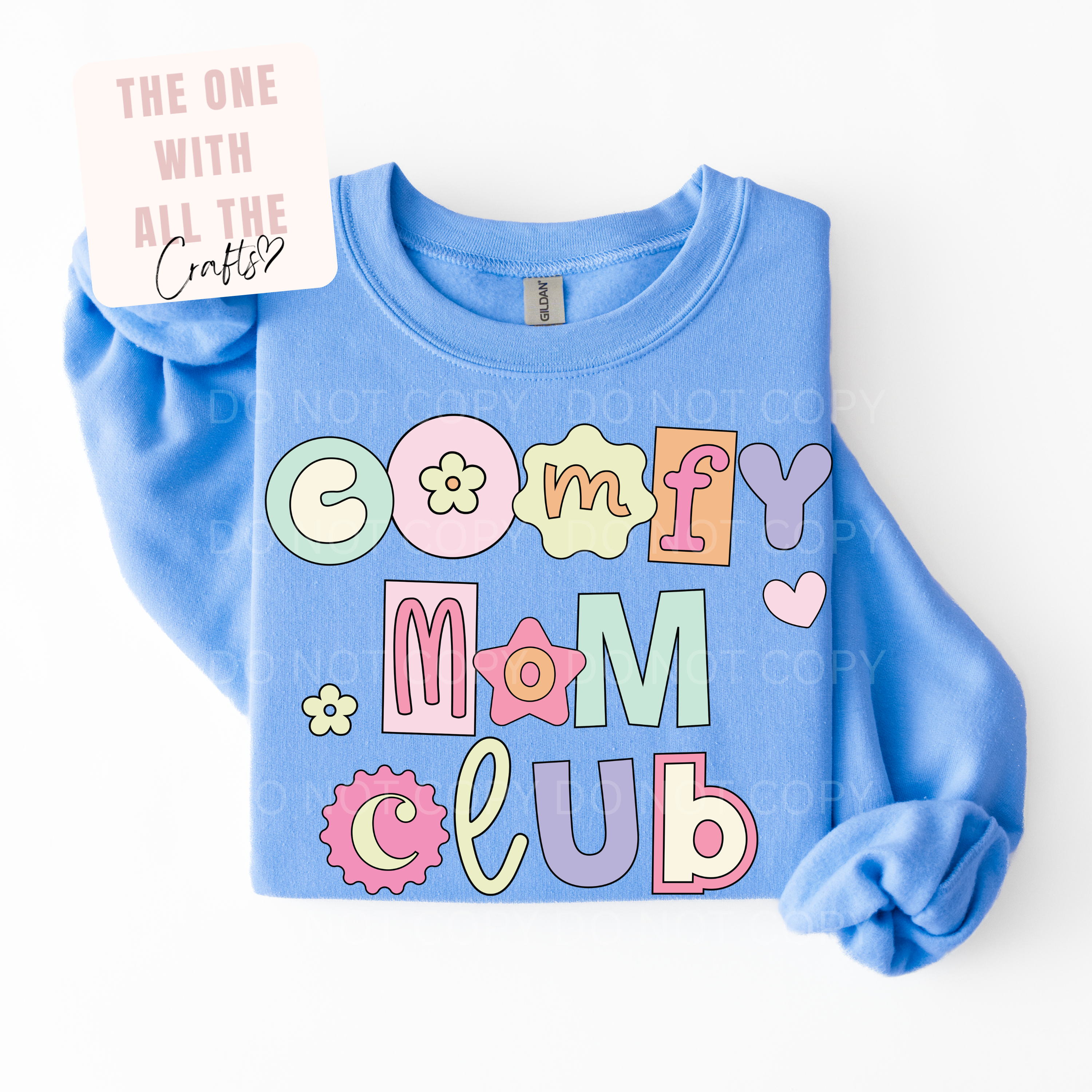 Blue sweatshirt with colorful 'Comfy Mom Club' text on a white background