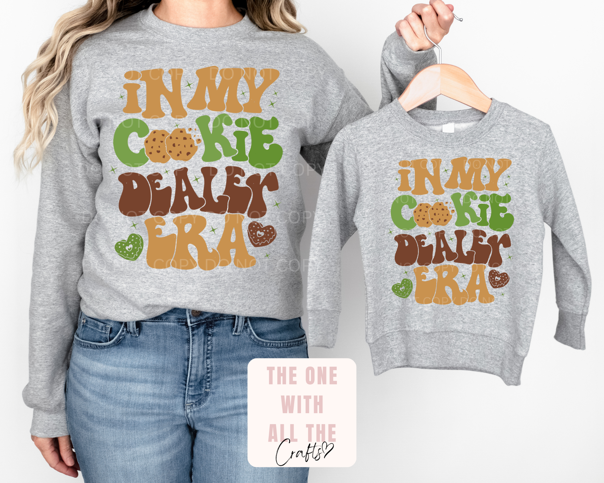 Two gray sweatshirts with colorful text design on a white background