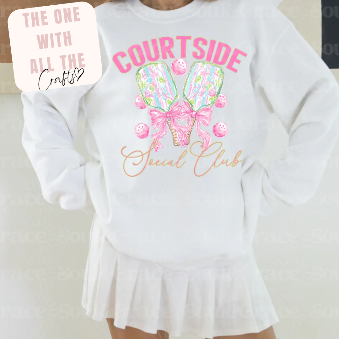 White sweatshirt with 'Courtside Social Club' design and a skirt on a plain background