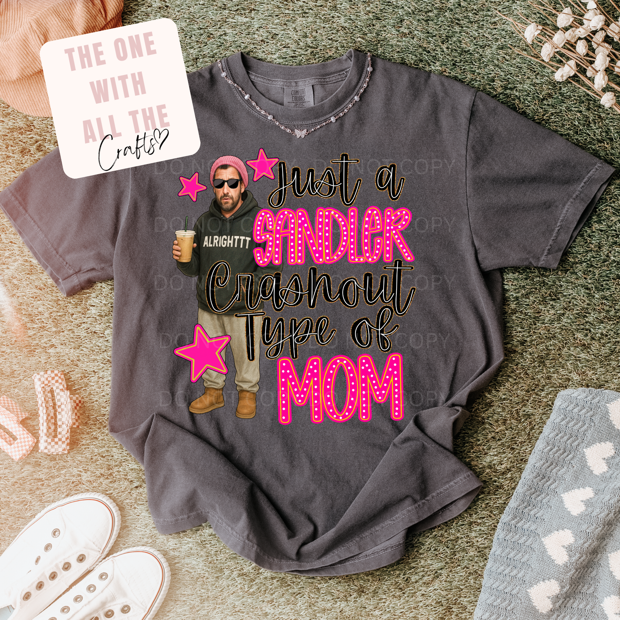 Gray t-shirt with graphic design and text on a textured surface
