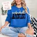 Person wearing a blue sweatshirt with 'Crawfordsville Athenians' text, sitting on a couch.