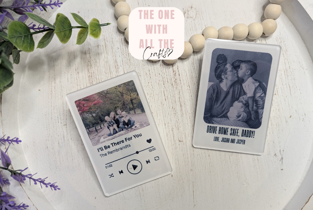 Two playing card-sized photo prints on a wooden surface with decorative elements.