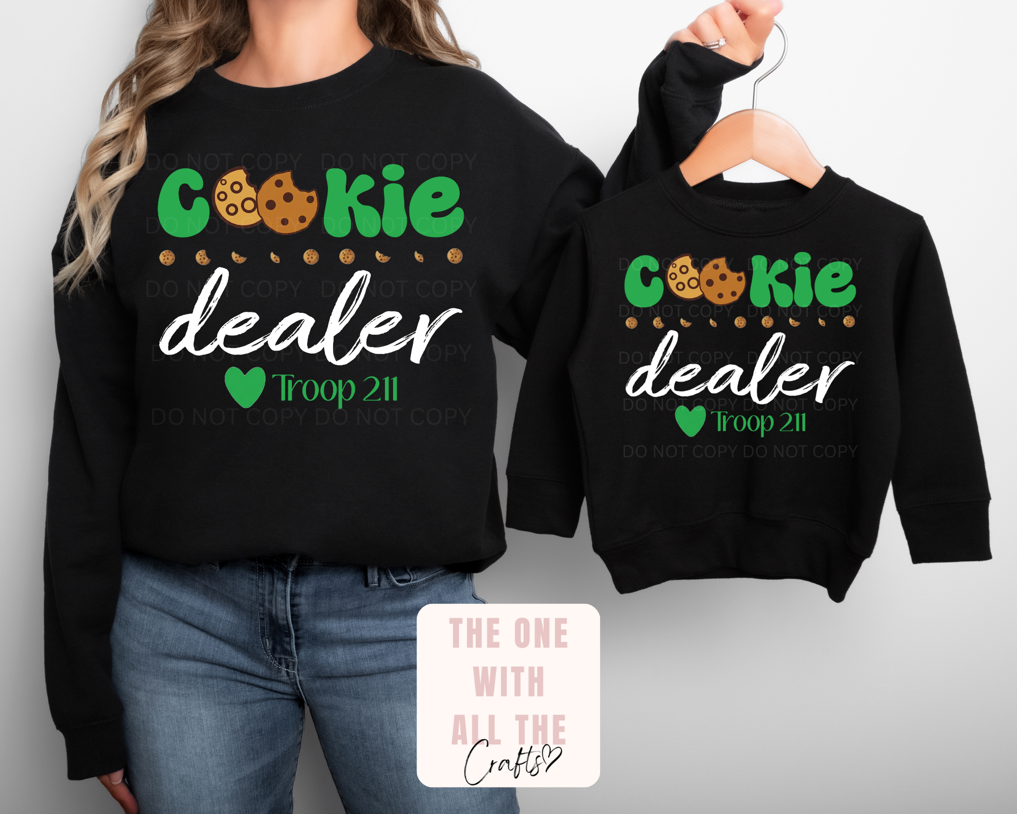 Black sweatshirts with 'Cookie Dealer' text and graphics on a plain background