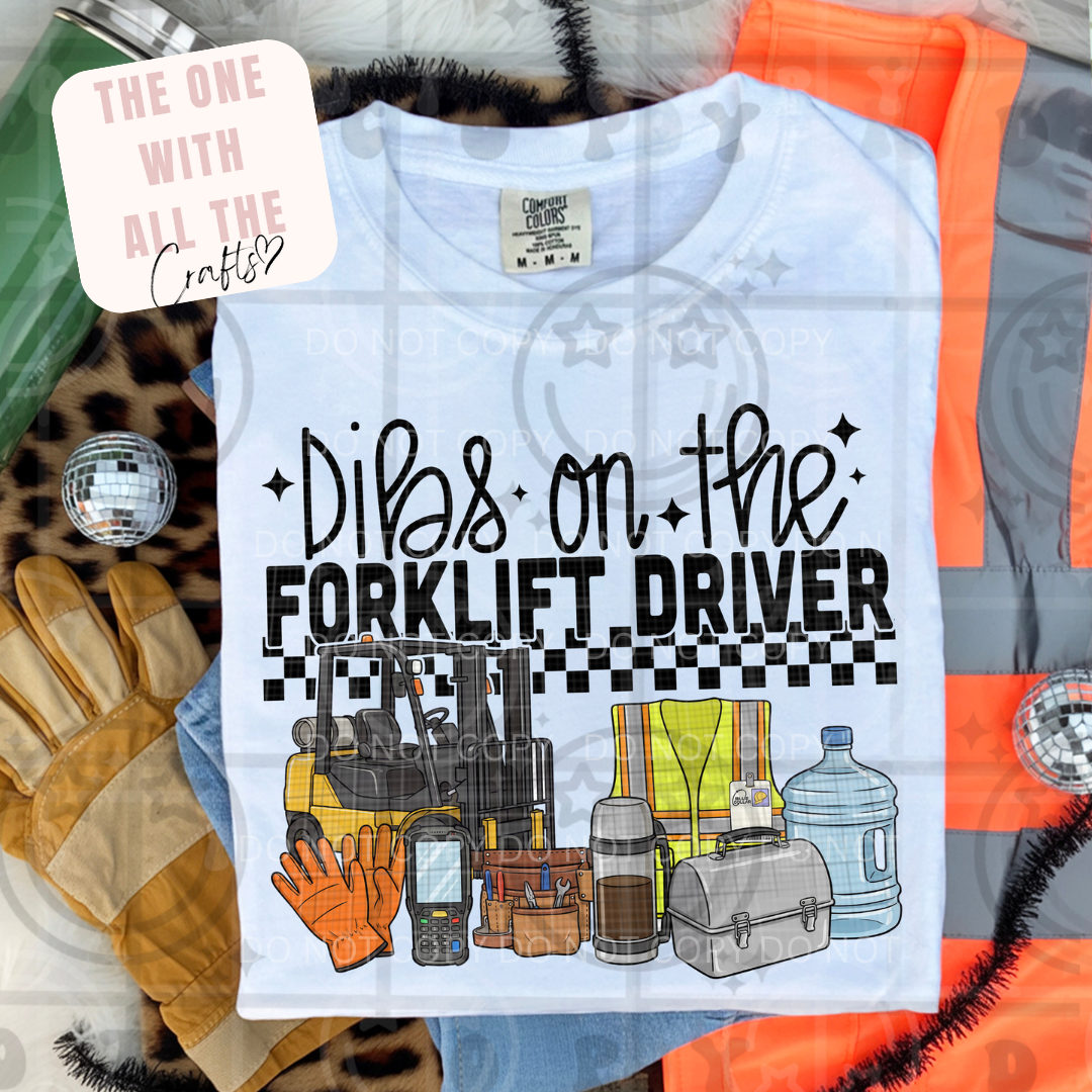 T-shirt with 'Dibs on the Forklift Driver' graphic and text 'The One with All the Crafts' on a colorful background.