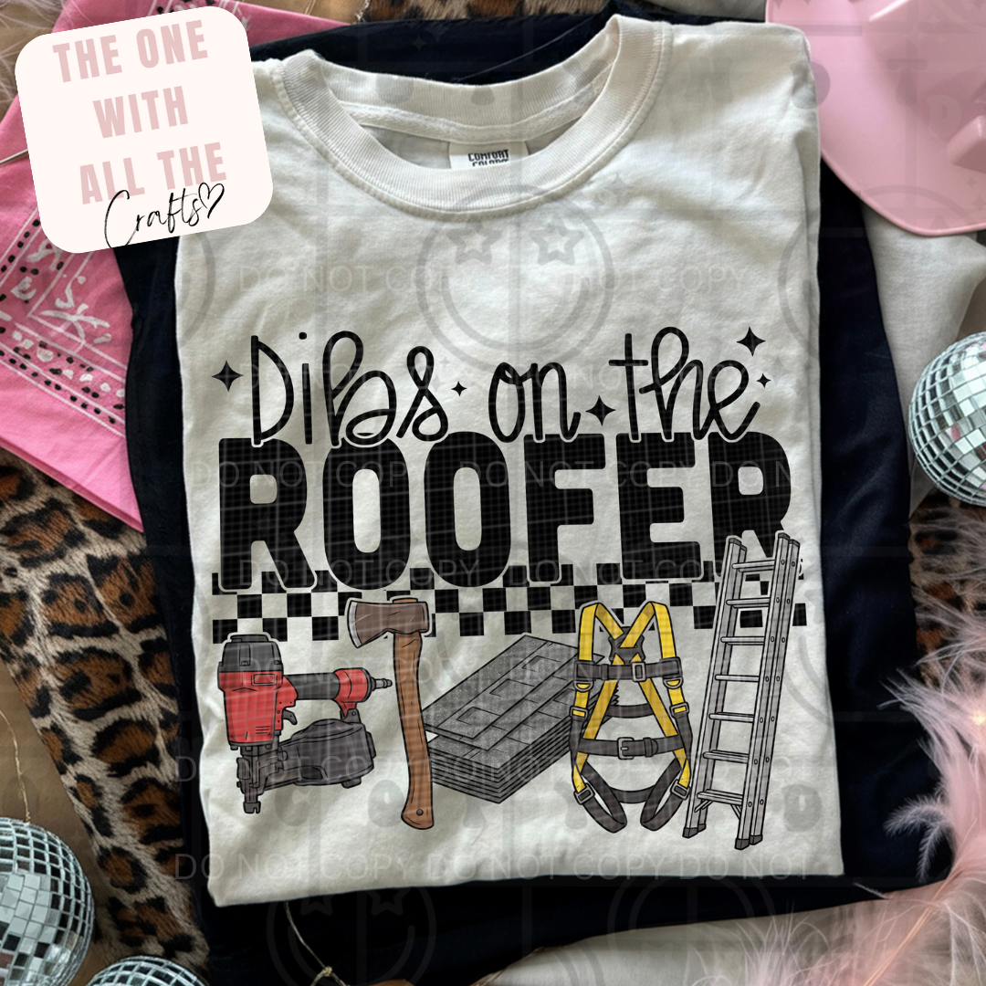 T-shirt with 'Dibs on the Roofer' text and tools graphic, displayed with accessories.