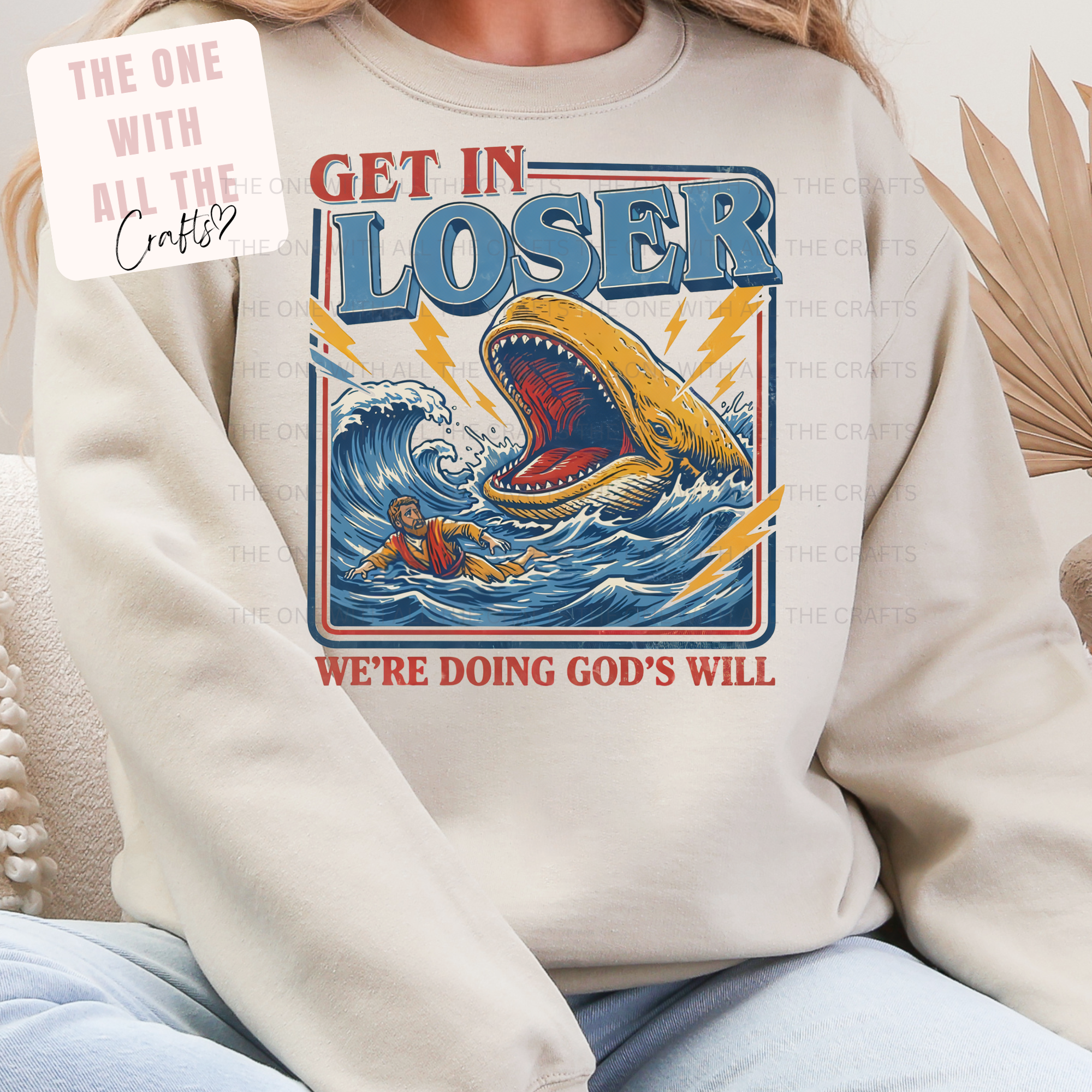 Person wearing a sweatshirt with a graphic design featuring a shark and text.