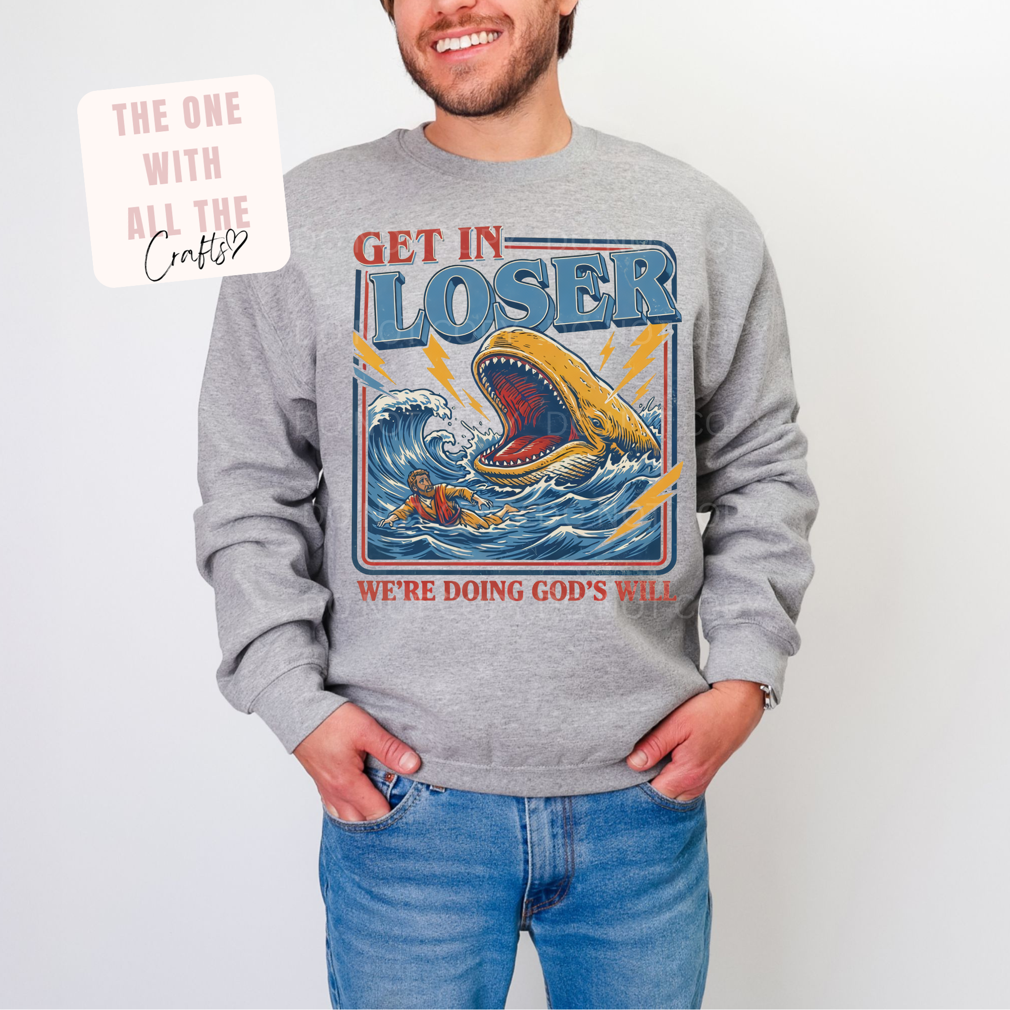 Person wearing a gray sweatshirt with a graphic design and text.