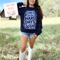 Woman wearing a navy sweatshirt with text outdoors