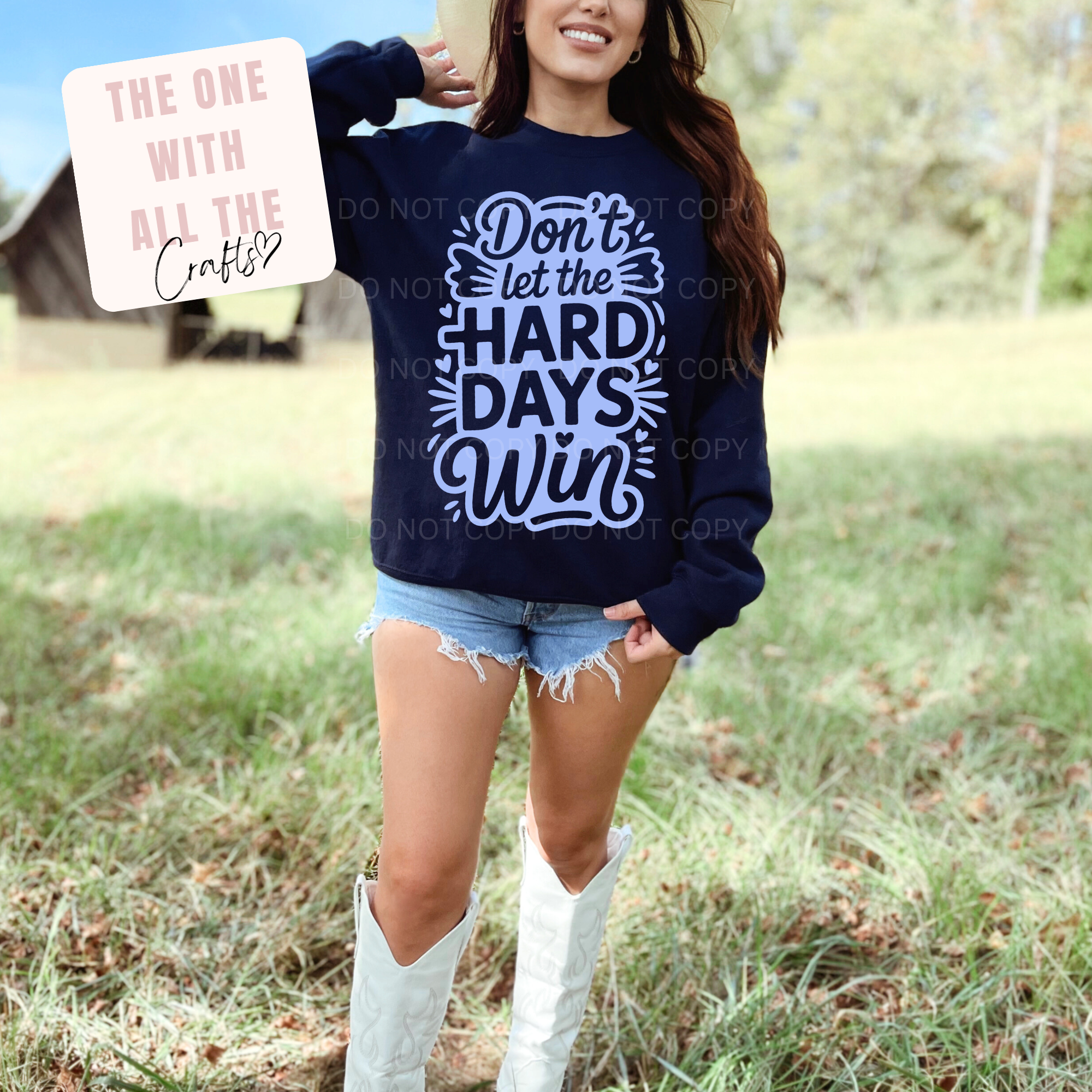 Woman wearing a navy sweatshirt with text outdoors