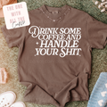 Brown sweatshirt with white text on a textured surface