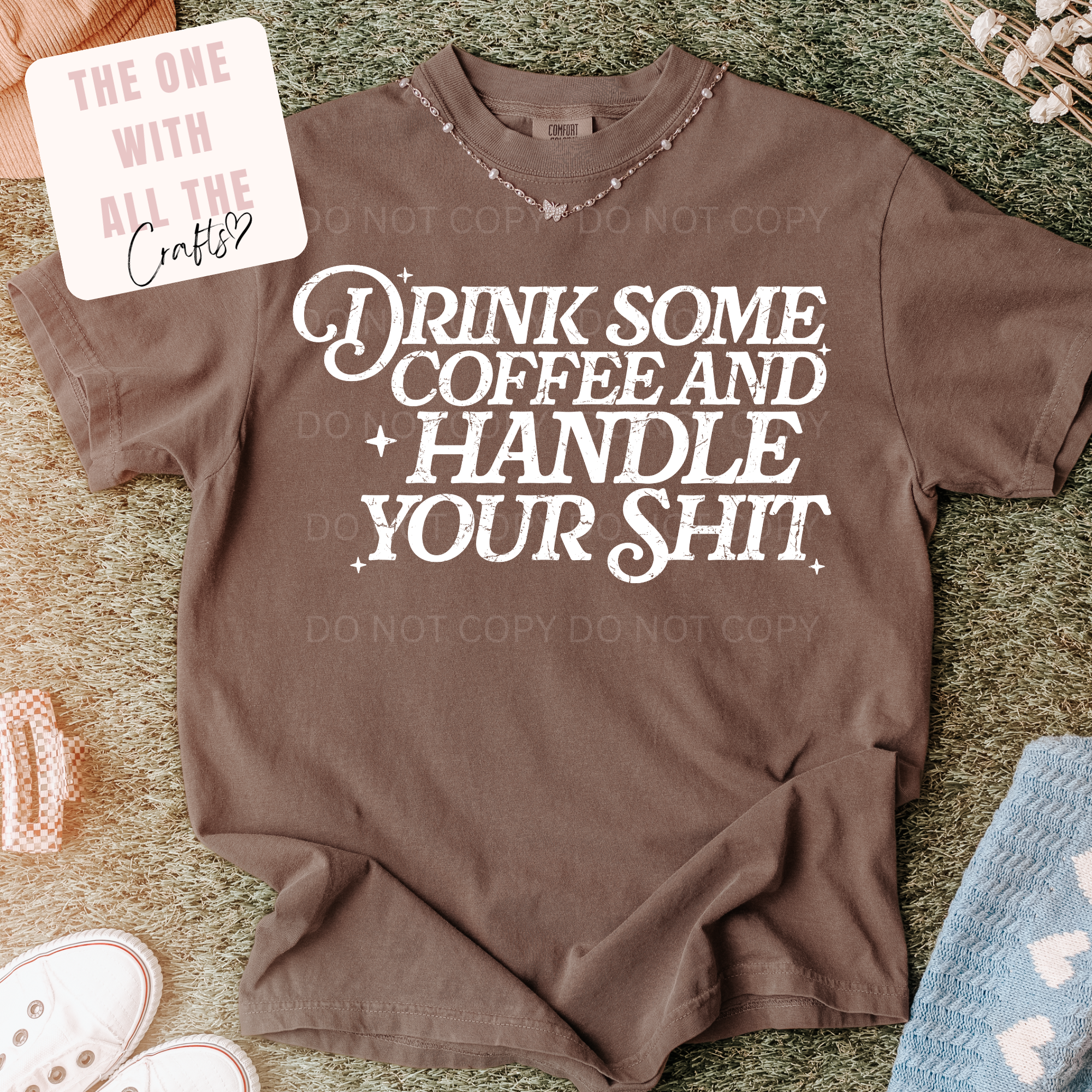 Brown sweatshirt with white text on a textured surface