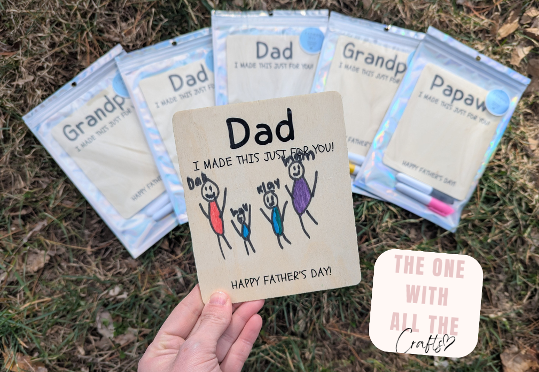 Handmade Father's Day craft with personalized message held over a set of small bags.