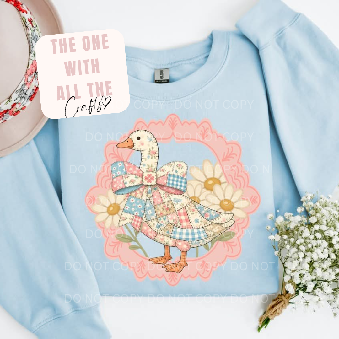 Light blue sweatshirt with a decorative duck design on a white background