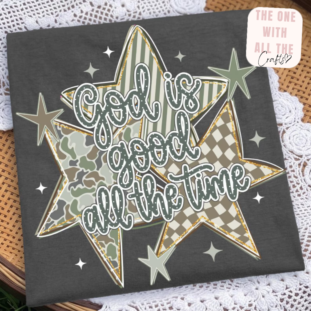 Decorative sign with star design and text 'God is good all the time' on a textured surface.