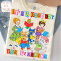 Children's t-shirt with colorful characters and text on a white background