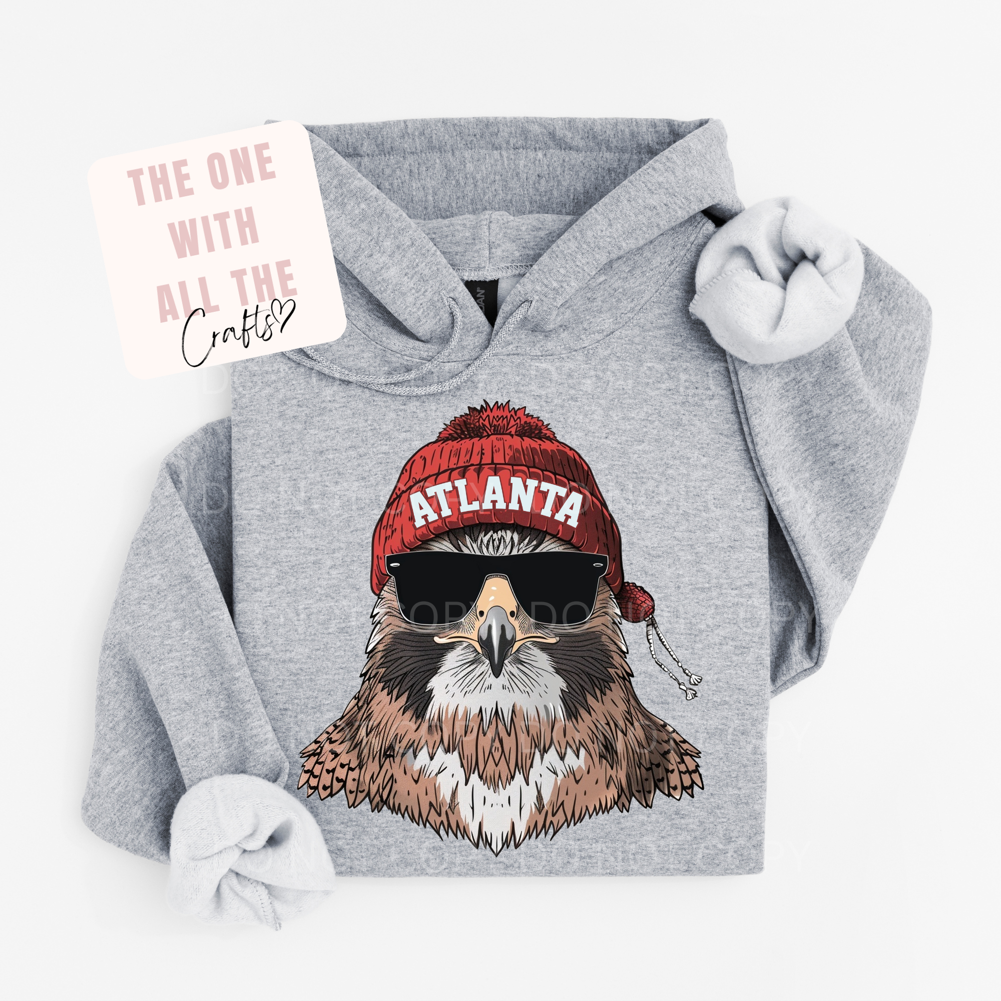 Gray hoodie with an eagle wearing a red 'Atlanta' beanie and sunglasses on a white background.