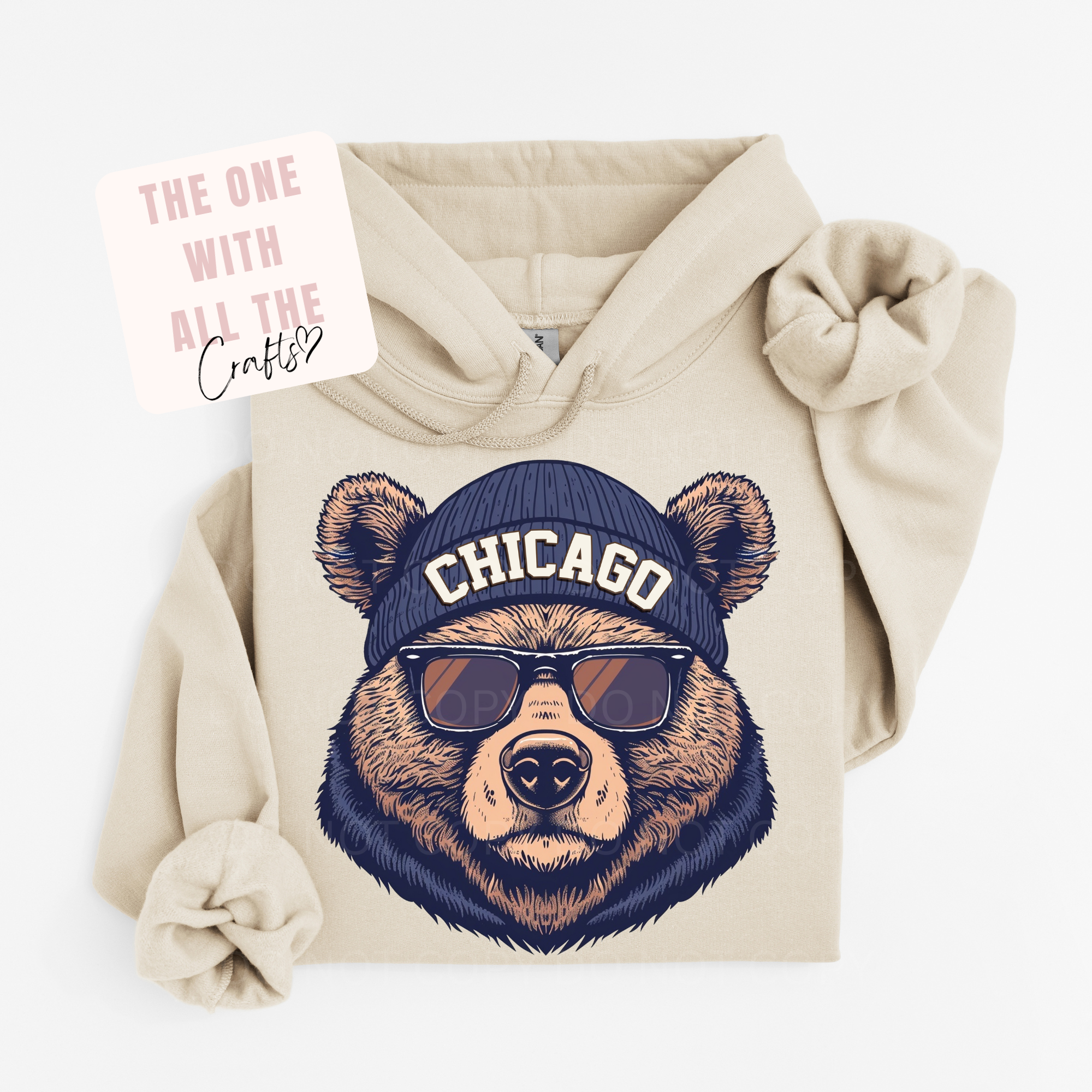 Beige hoodie with bear design wearing a 'Chicago' cap and sunglasses, on a white background.