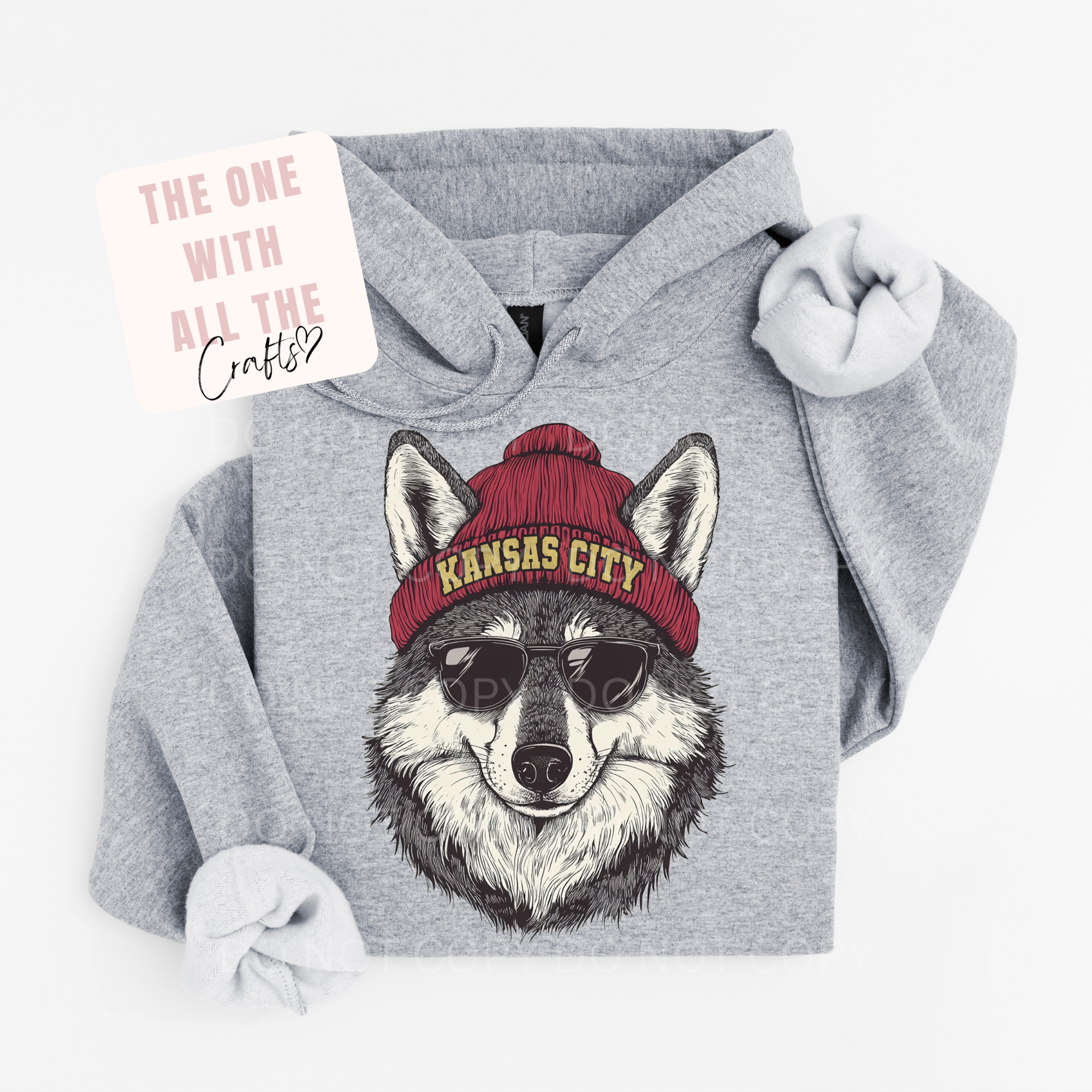Gray hoodie with a wolf graphic wearing a red 'Kansas City' beanie on a white background