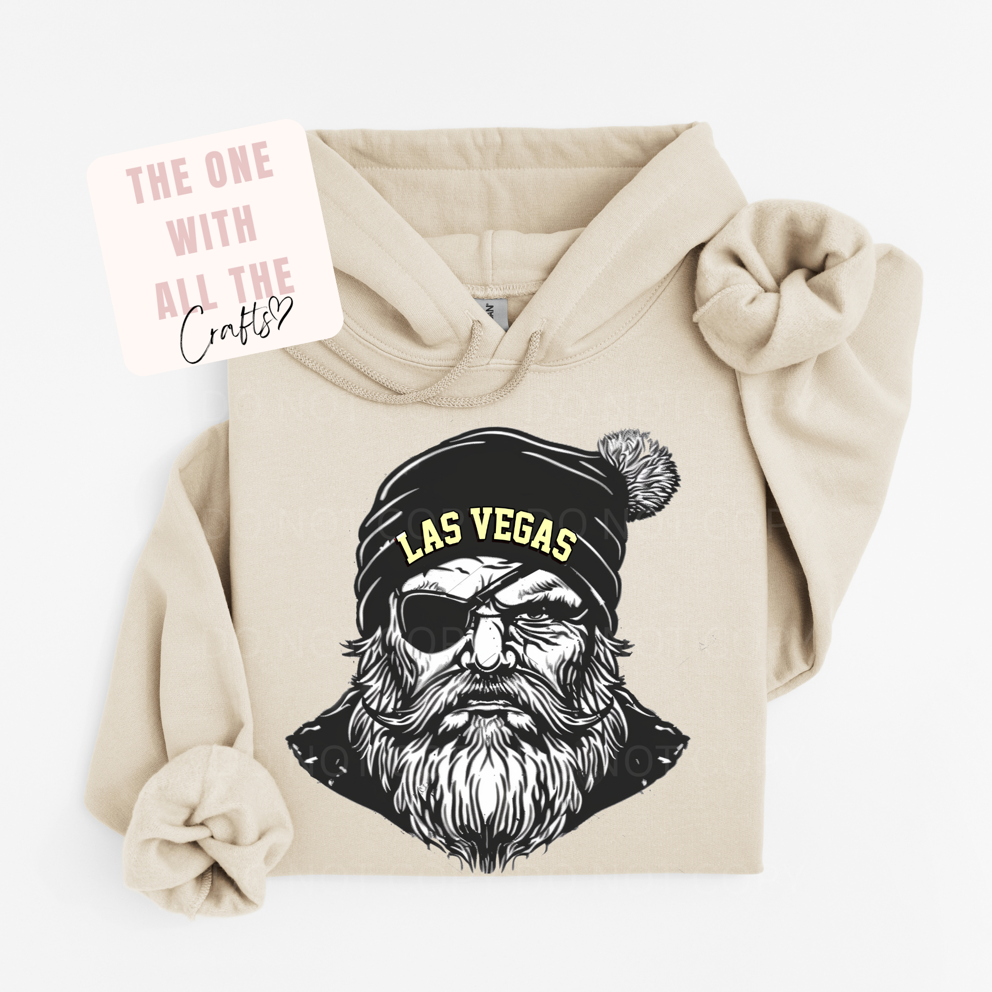 Beige hoodie with a graphic of a bearded man wearing a 'Las Vegas' beanie on a white background.