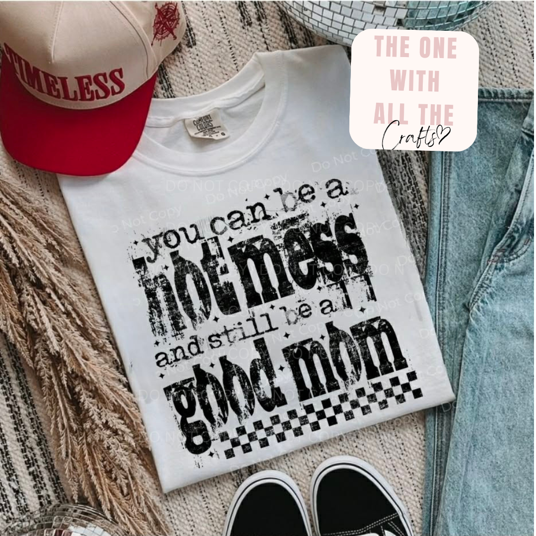 White t-shirt with black text on a textured surface with a cap and jeans.
