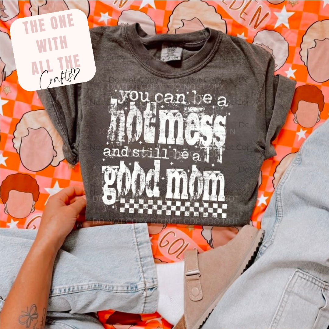 Gray t-shirt with text held by a person on a colorful background