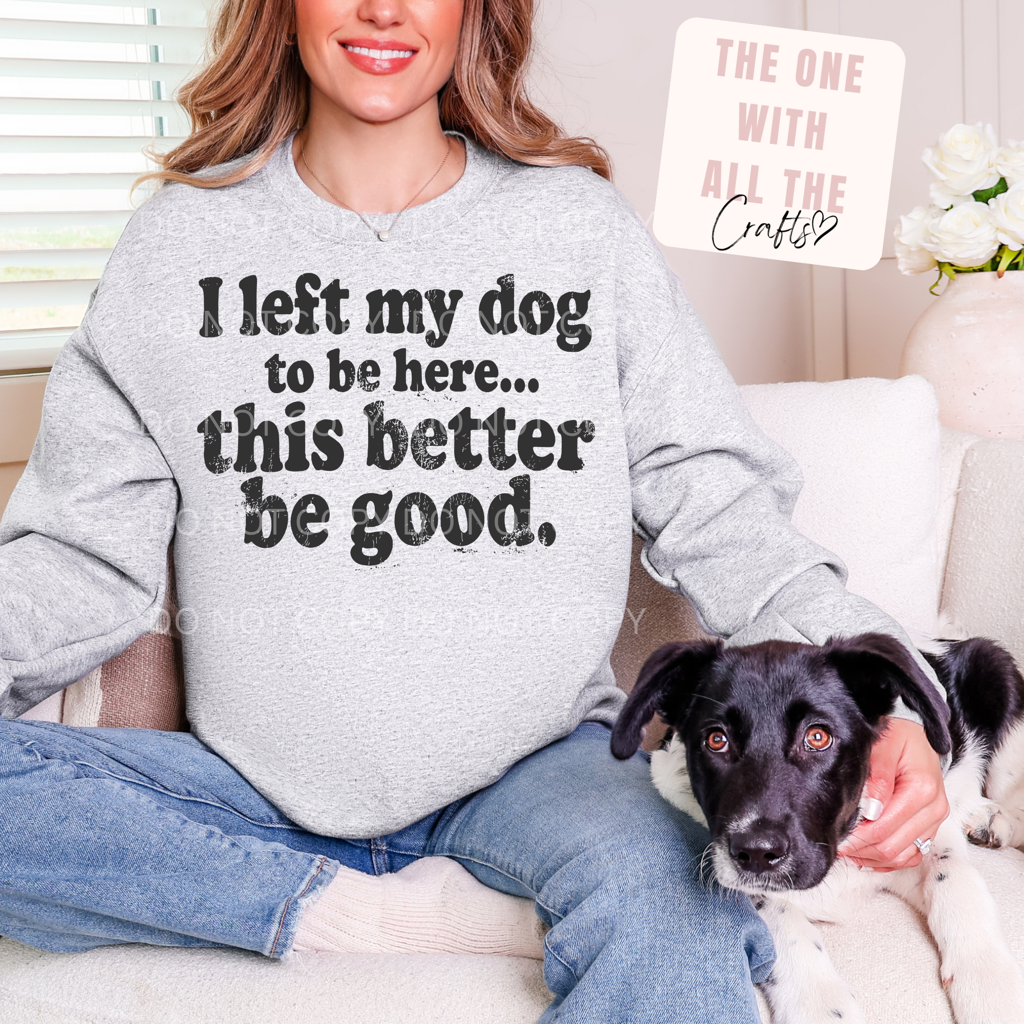 Person wearing a sweatshirt with a humorous dog-related message, sitting on a couch with a dog.