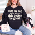 Person wearing a black sweatshirt with a humorous dog quote, sitting next to a dog.