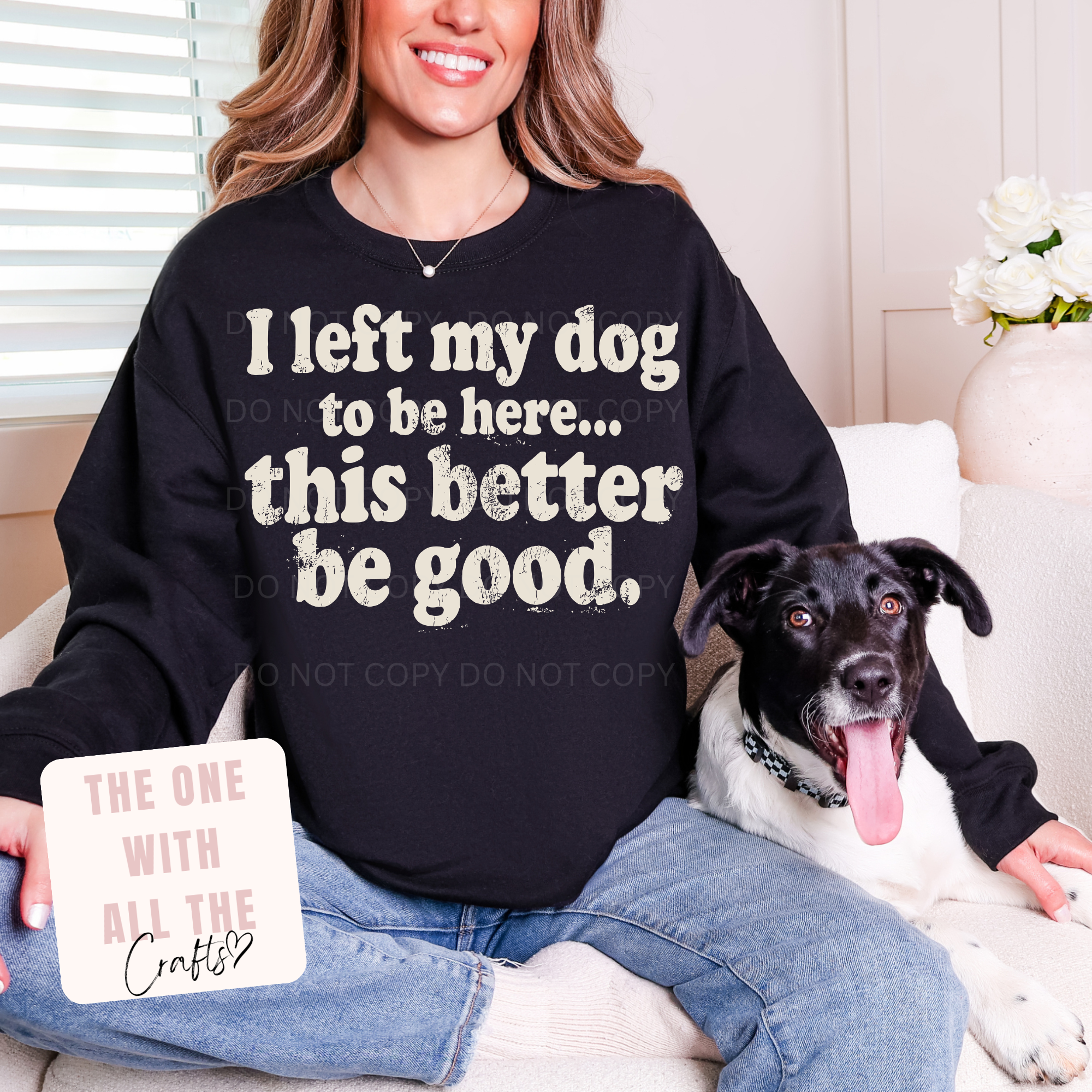 Person wearing a black sweatshirt with a humorous dog quote, sitting next to a dog.