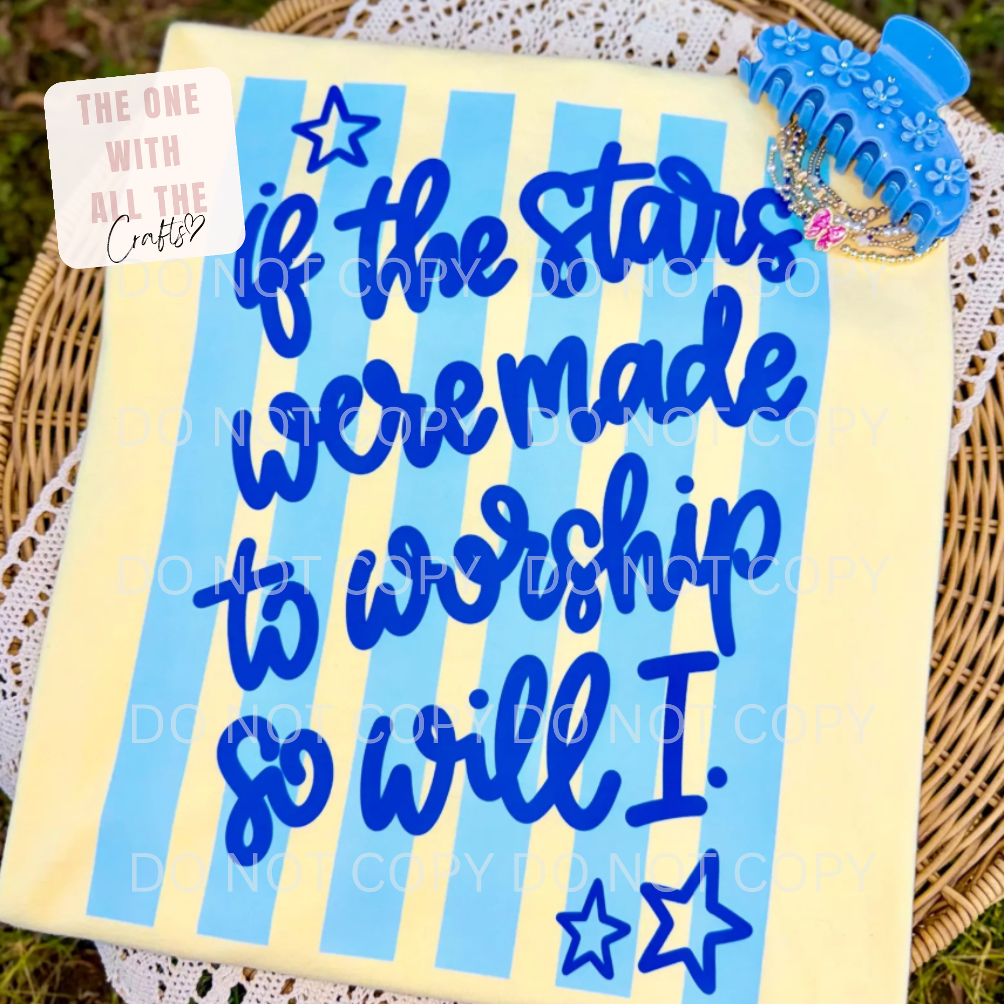 Decorative notebook with blue text and stars on a yellow background, placed on a woven surface.
