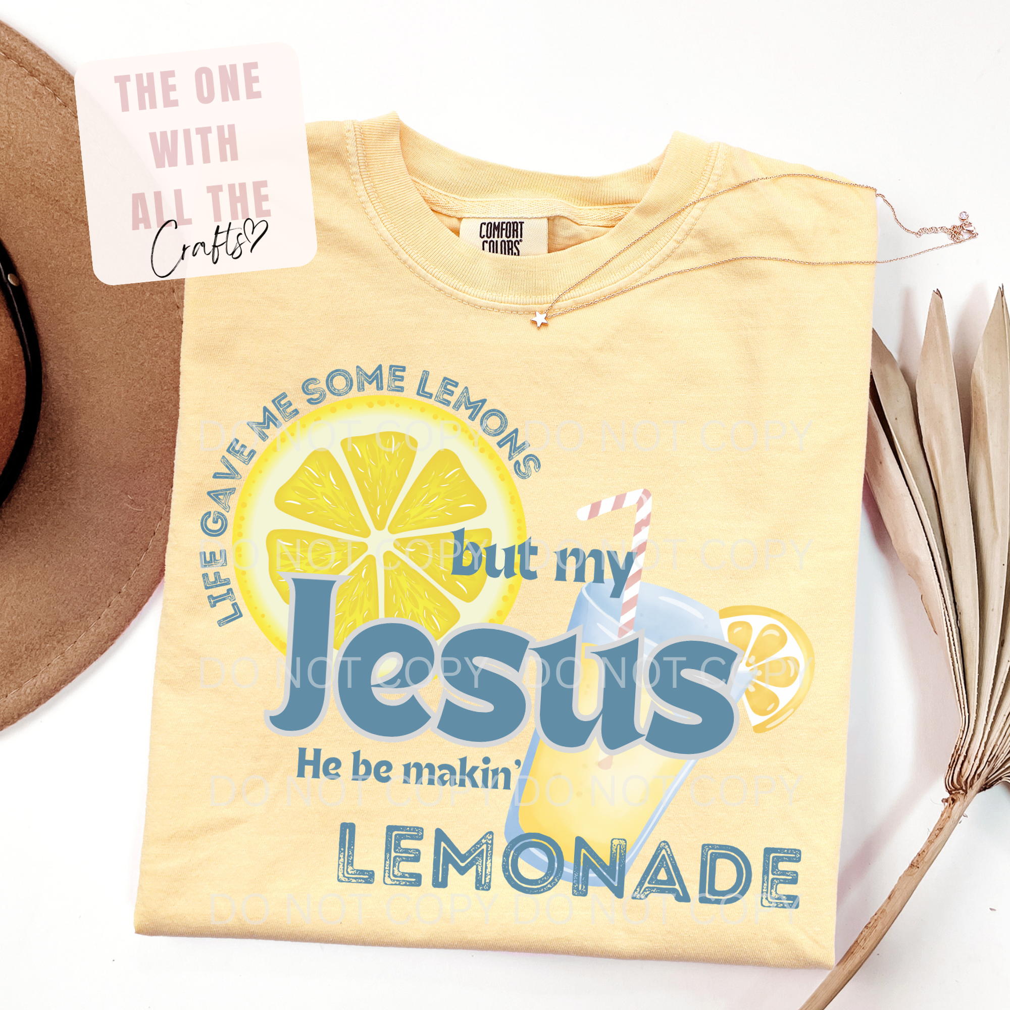 Yellow t-shirt with lemon-themed design and text on a white surface.