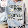 Gray sweatshirt with text and daisy graphics worn by a person, with a disco ball in the background.