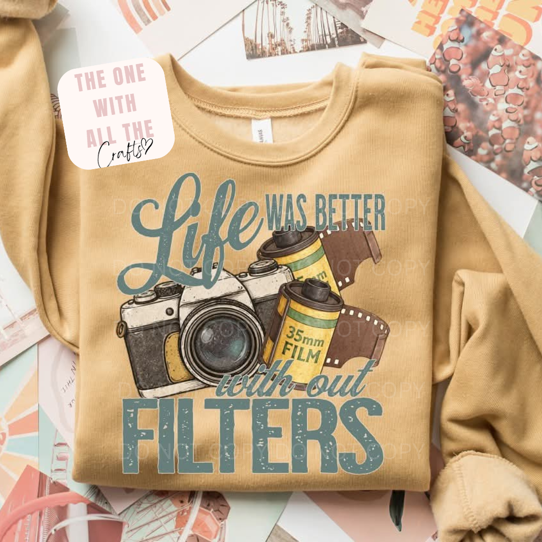 Beige sweatshirt with camera graphic and text on a colorful surface