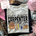 White t-shirt with graphic design and text 'Just a girl who loves her Carpenter' on a patterned surface.