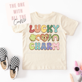 Beige t-shirt with colorful text and graphics on a white background