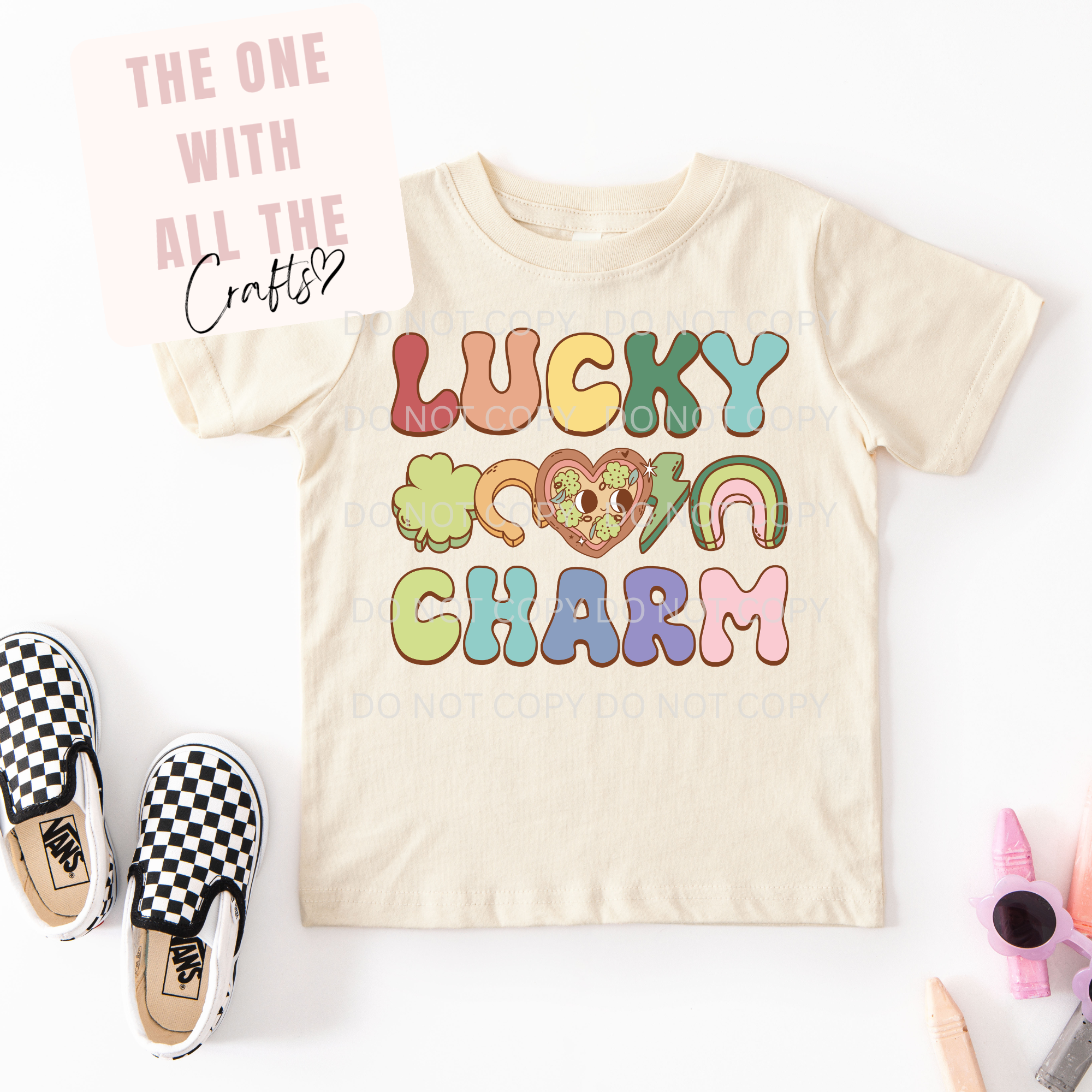 Beige t-shirt with colorful text and graphics on a white background