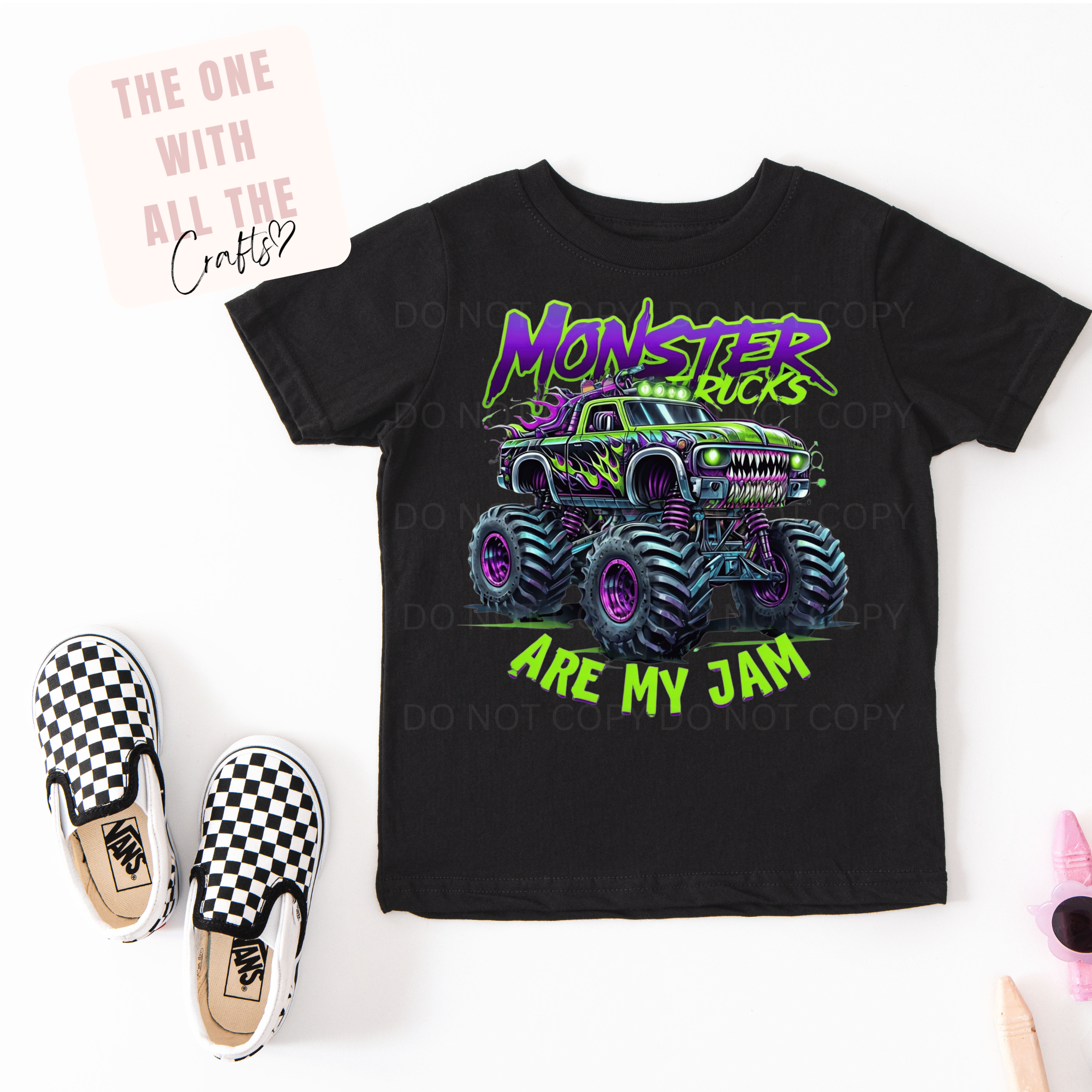 Black t-shirt with monster truck graphic and text, paired with checkered shoes on a white background.