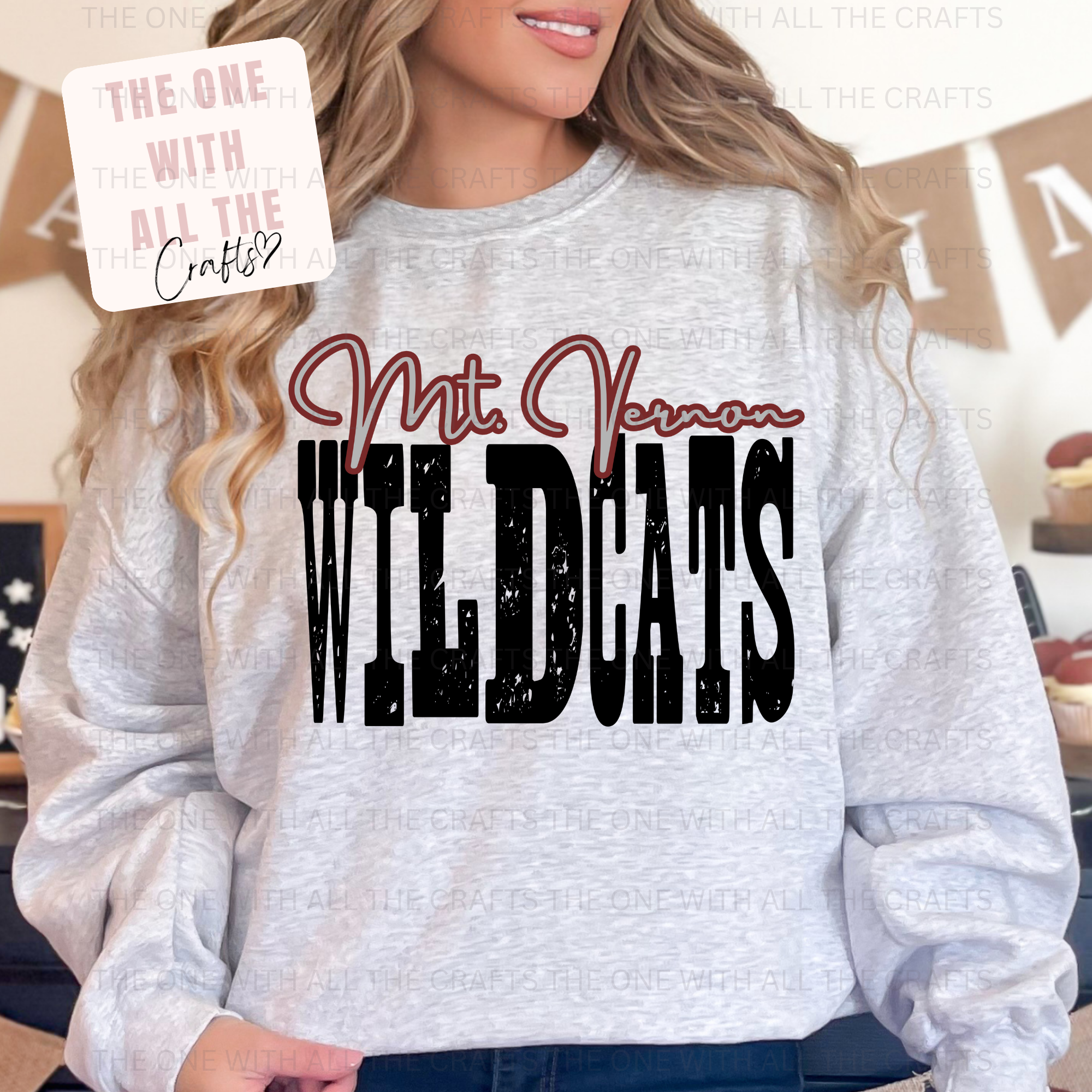 Person wearing a gray sweatshirt with 'Mt Vernon Wildcats' text, with a blurred background.