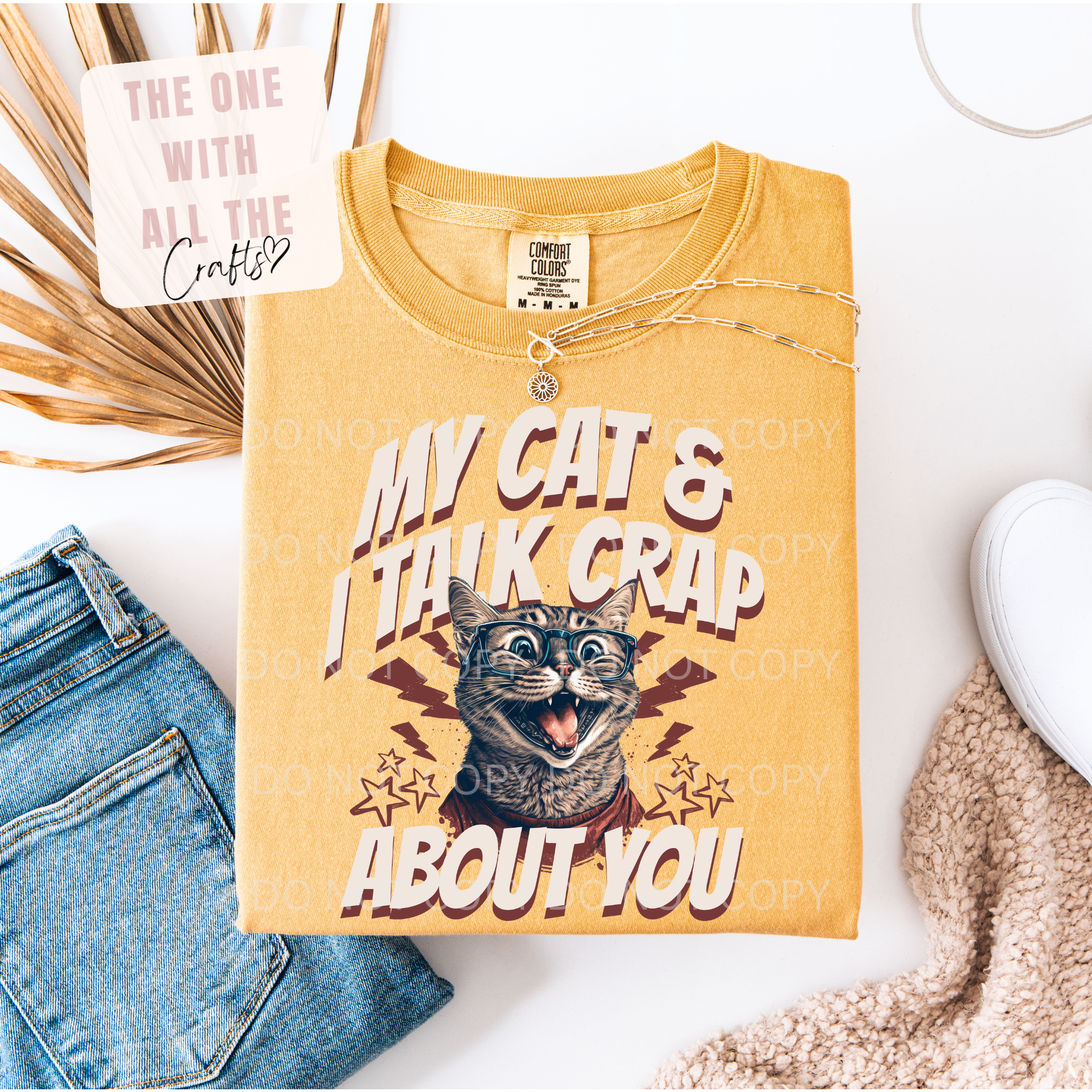 Yellow t-shirt with a cat graphic and text on a white background