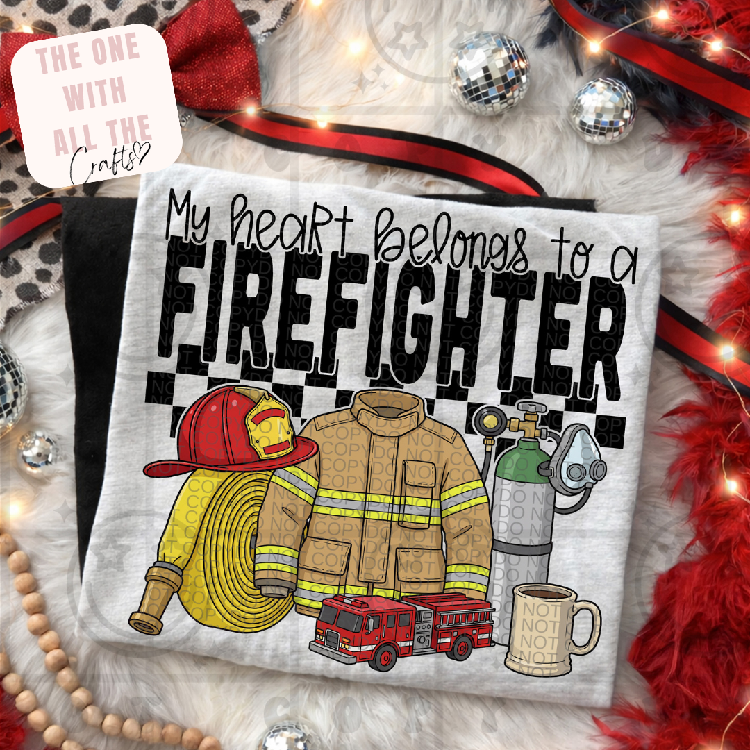 T-shirt with firefighter-themed design and text 'My heart belongs to a firefighter' on a festive background.