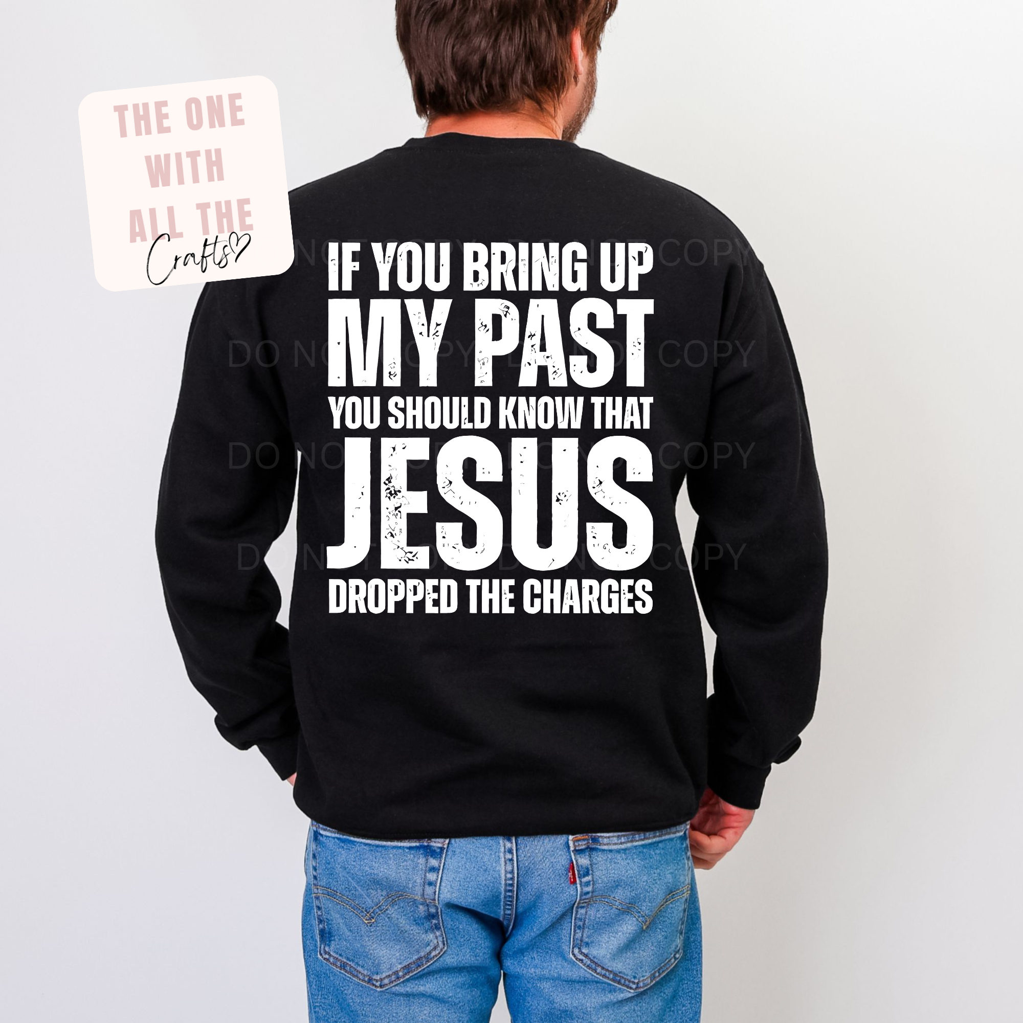 Person wearing a black sweatshirt with a humorous text design on the back, standing against a plain background.