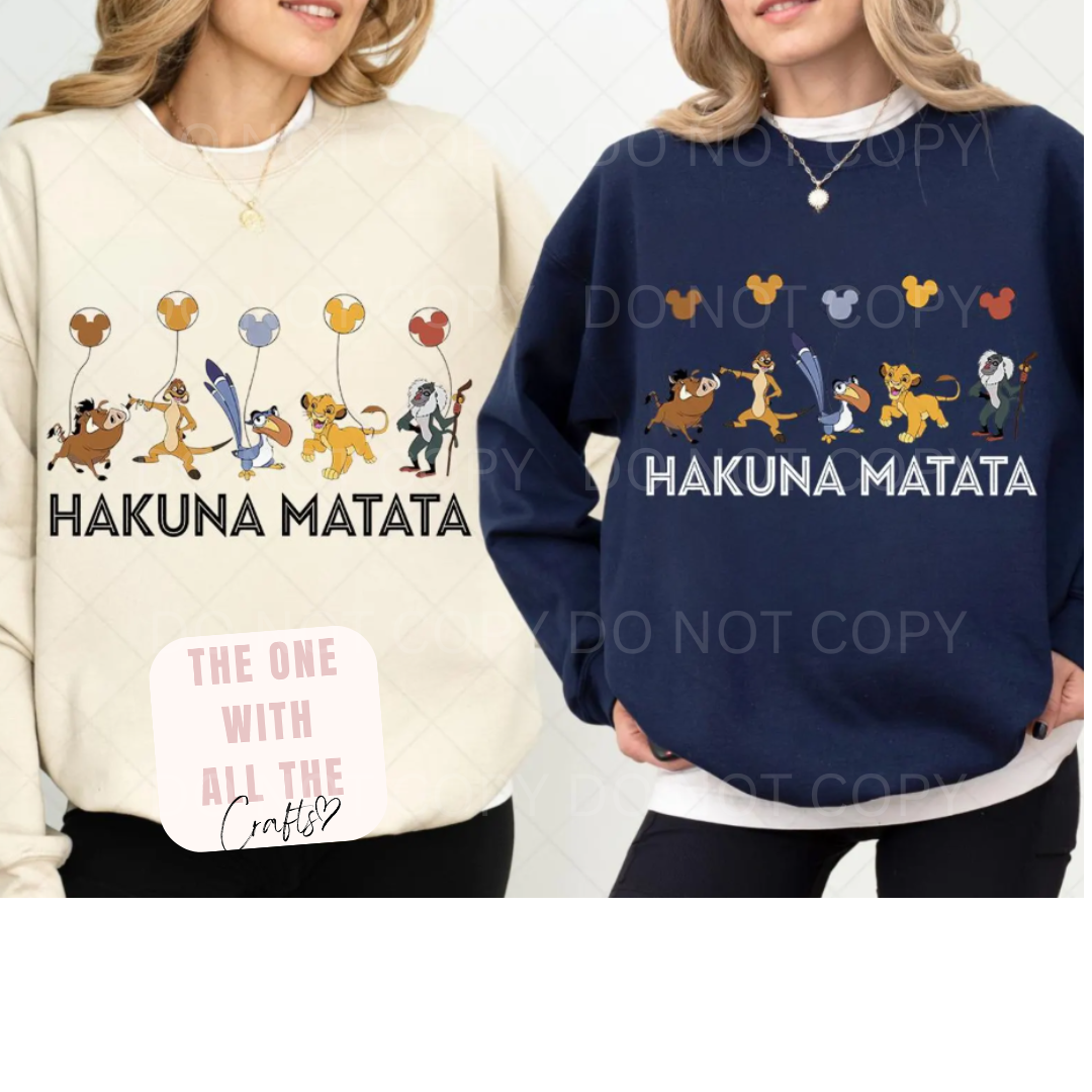 Two sweatshirts with 'Hakuna Matata' text and cartoon characters on a white background.
