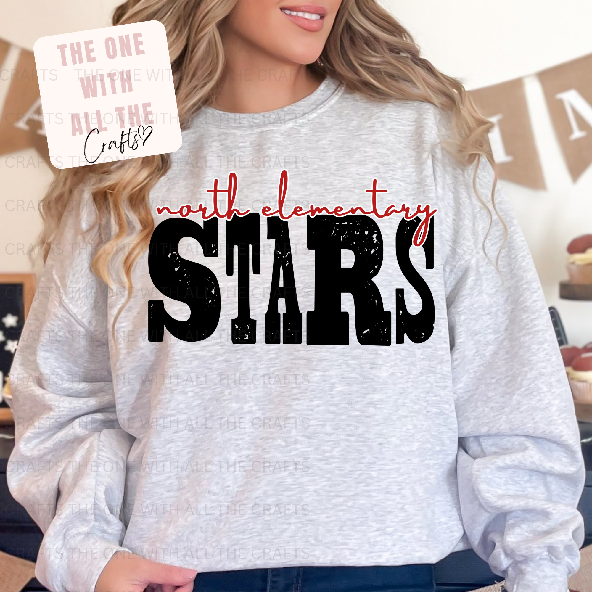 Person wearing a gray sweatshirt with 'north elementary stars' text, standing in a casual setting.
