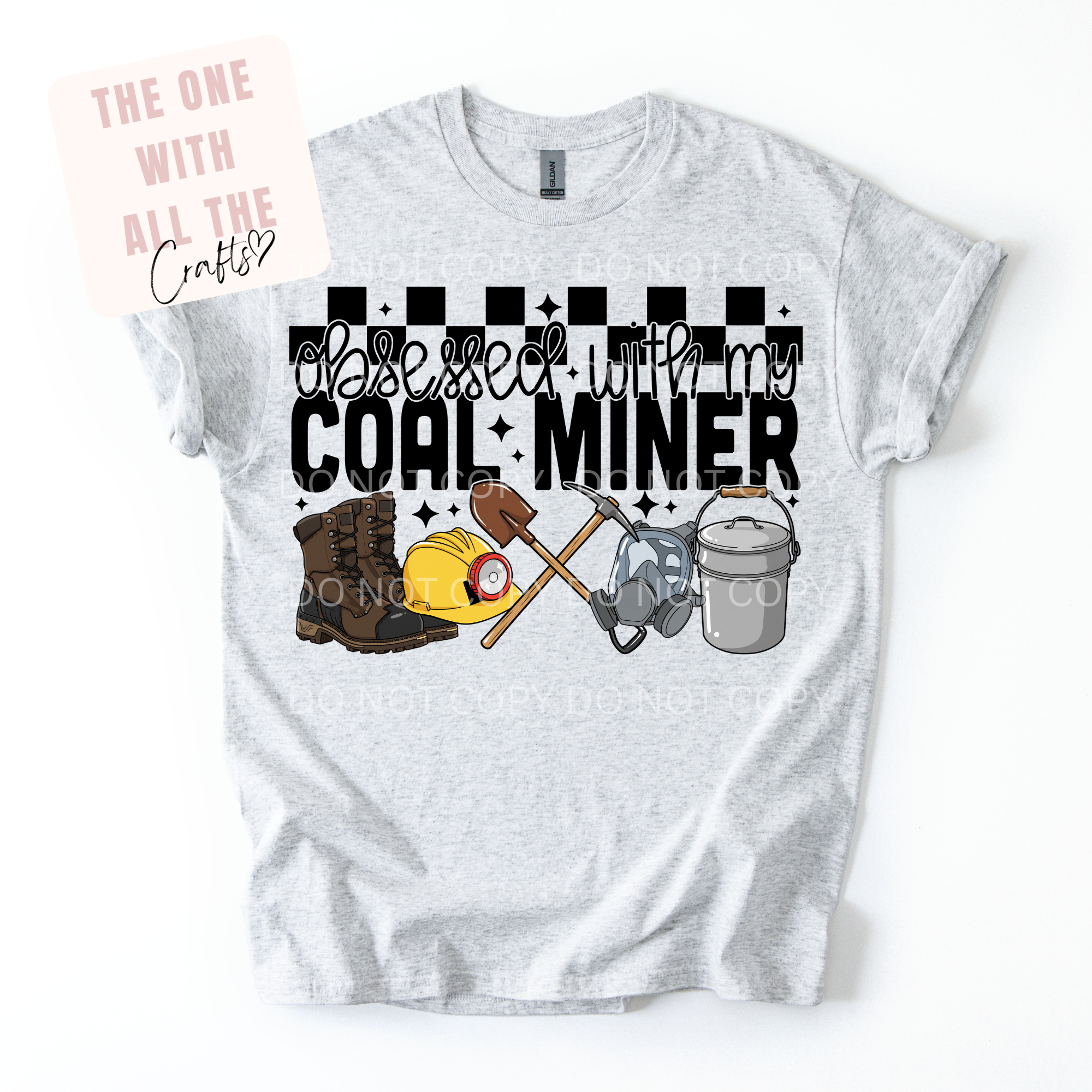 Gray t-shirt with graphic design and text 'Obsessed with my coal miner' on a white background