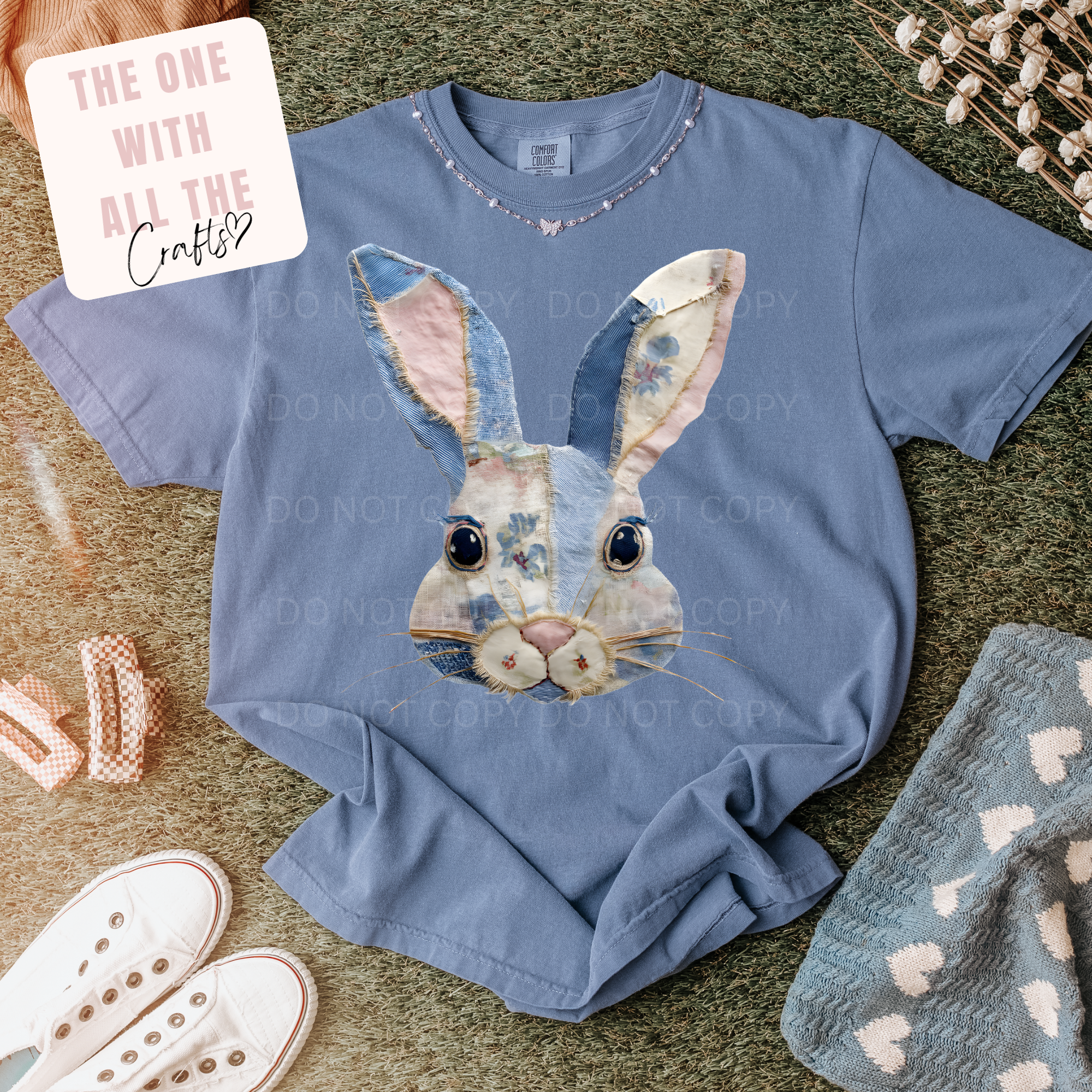 Blue t-shirt with a rabbit graphic on a textured surface
