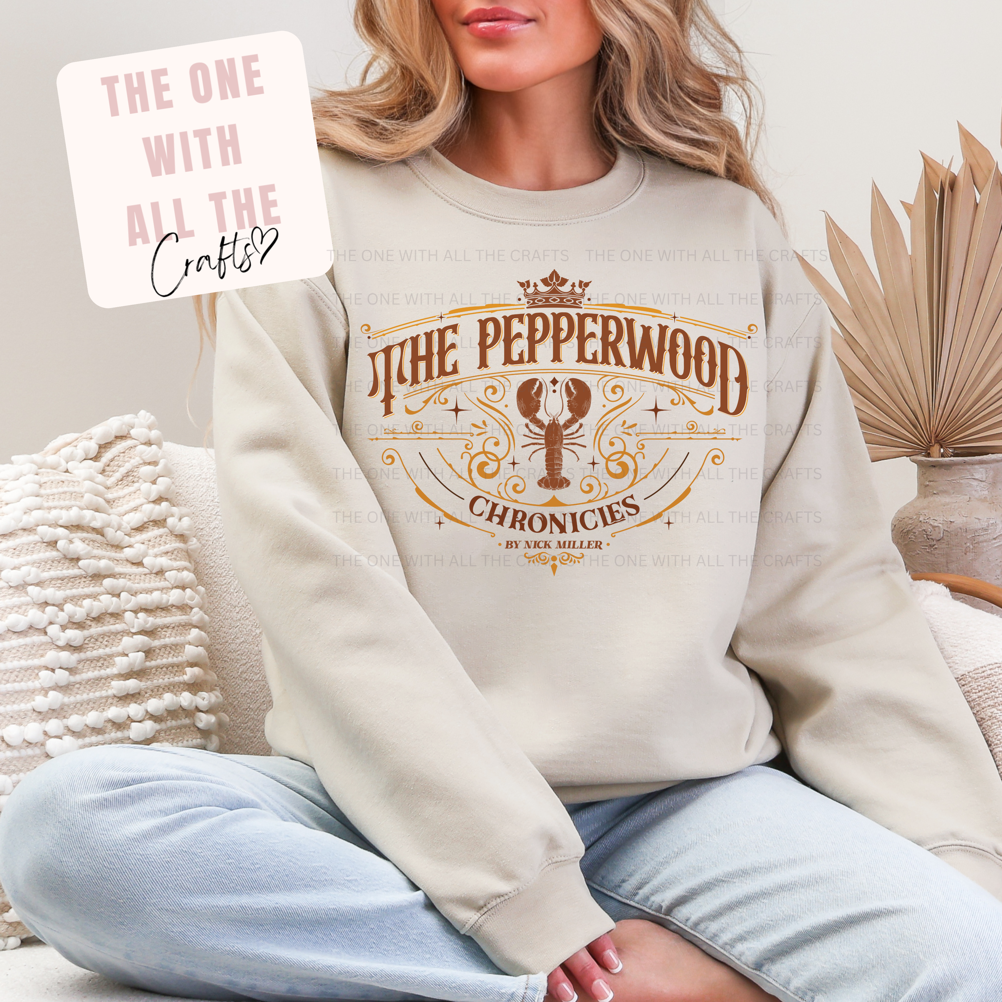 Person wearing a beige sweatshirt with 'The Pepperwood Chronicles' design, sitting on a couch.