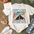 White t-shirt with graphic design and text on a surface with accessories.